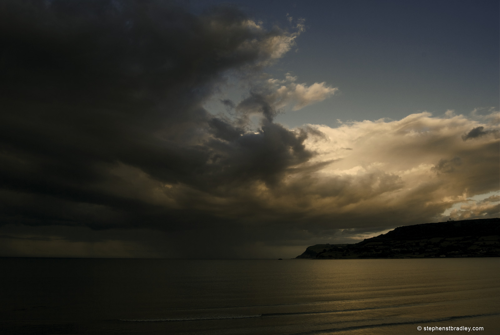 Landscape photograph of rain clouds over Irish Sea from Carnlough, Northern Ireland, by Stephen Bradley photographer - photograph 2546.