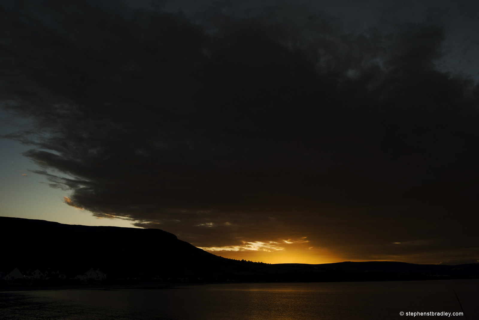 Landscape photograph of sun setting behind Tievebulliagh, Glens of Antrim, Northern Ireland, by Stephen Bradley photographer - photograph 2579.