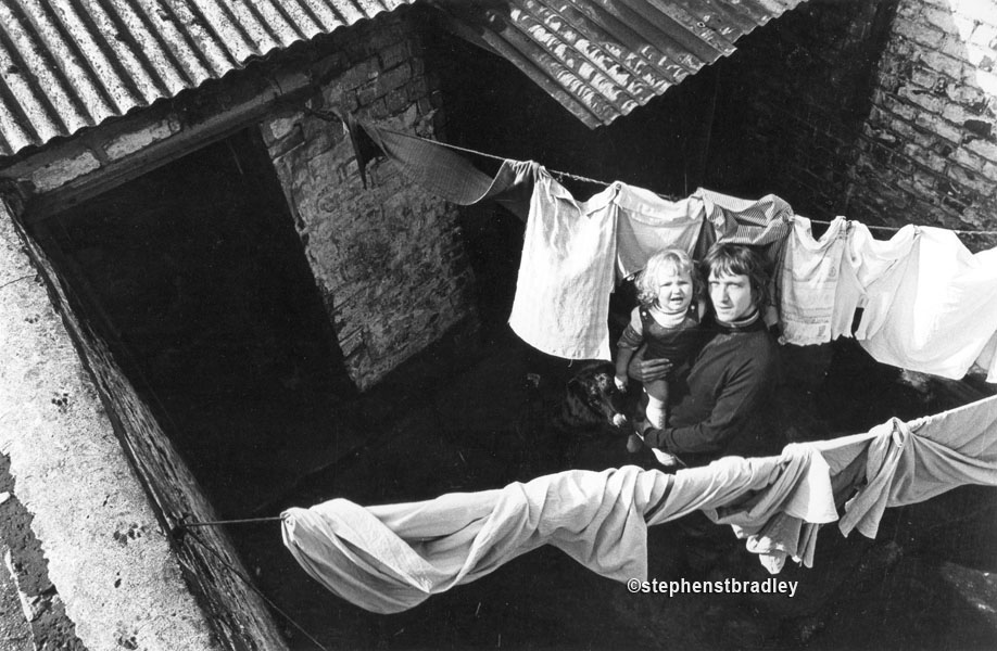 Young man, child and dog in working class back yard, Belfast, by Stephen S T Bradley, editorial, commercial, PR and advertising photographer, Dublin, Ireland