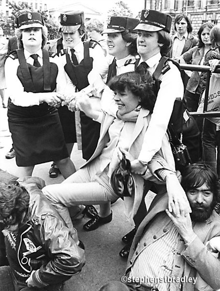 Young woman being grappled by female police officers, Belfast by Stephen S T Bradley, editorial, commercial, PR and advertising photographer, Dublin, Ireland