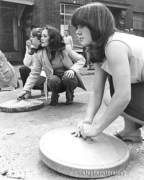 Women banging bin lids, Falls Road, Belfast, Northern Ireland, by Stephen S T Bradley, editorial, commercial, PR and advertising photographer, Dublin, Ireland