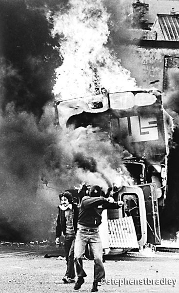 Rioters in front of burning vehicle, Bogside, Derry, Northern Ireland, by Stephen S T Bradley, editorial, commercial, PR and advertising photographer, Dublin, Ireland