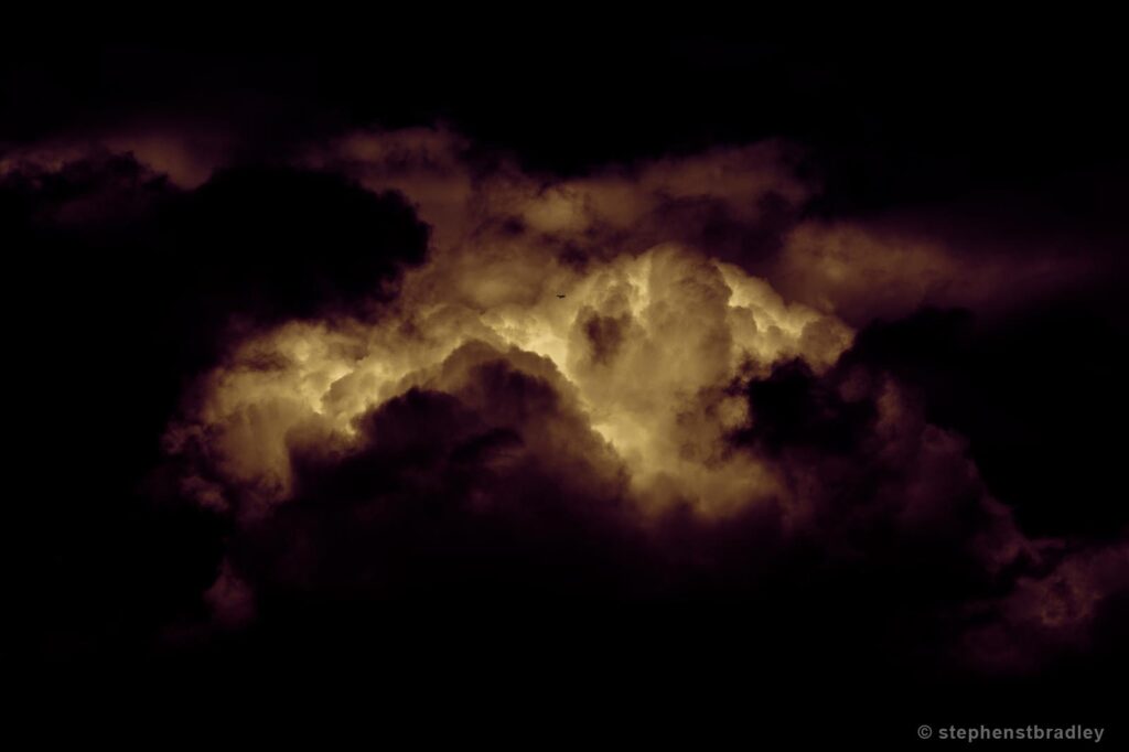 Silent Redux - an airplane is dwarfed amongst gargantuan clouds over Cave Hill, Northern Ireland. A contemporary limited edition fine art photo of clouds over Ireland by Stephen S T Bradley