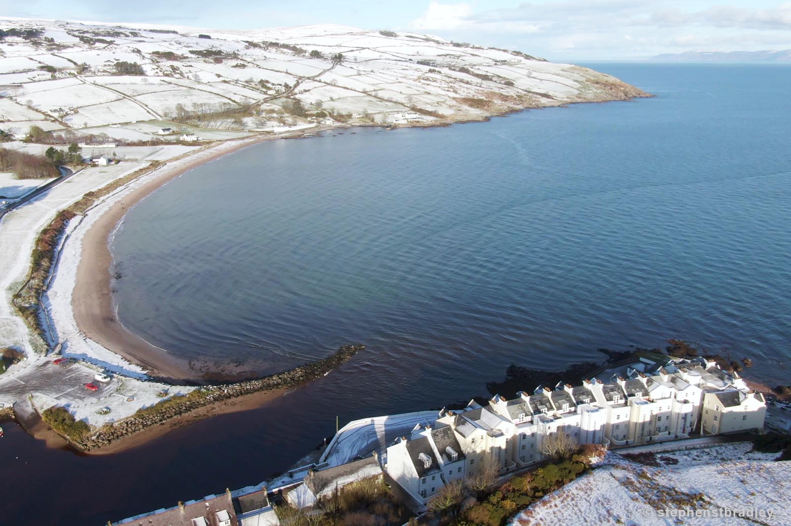 Aerial drone photography and video production services Dublin and Ireland portfolio - Cushendun village under snow in winter, video screenshot 4