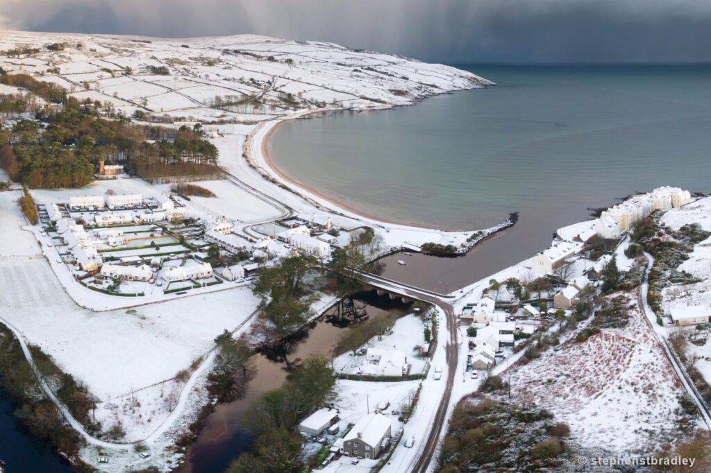 Aerial drone photography and video production services Dublin and Ireland portfolio - Cushendun village under snow in winter, Northern Ireland, video screenshot 6
