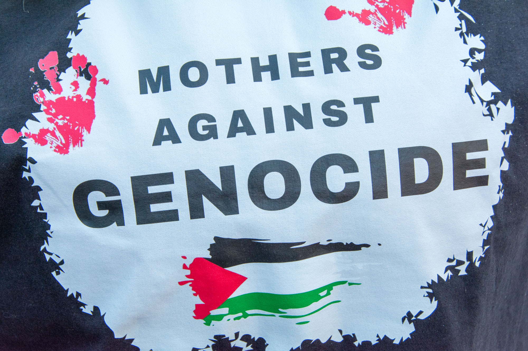 Mothers Against Genocide illustration on the shirt of an attendee at the Palestine march in Belfast. Photo 7611 by Stephen S T Bradley