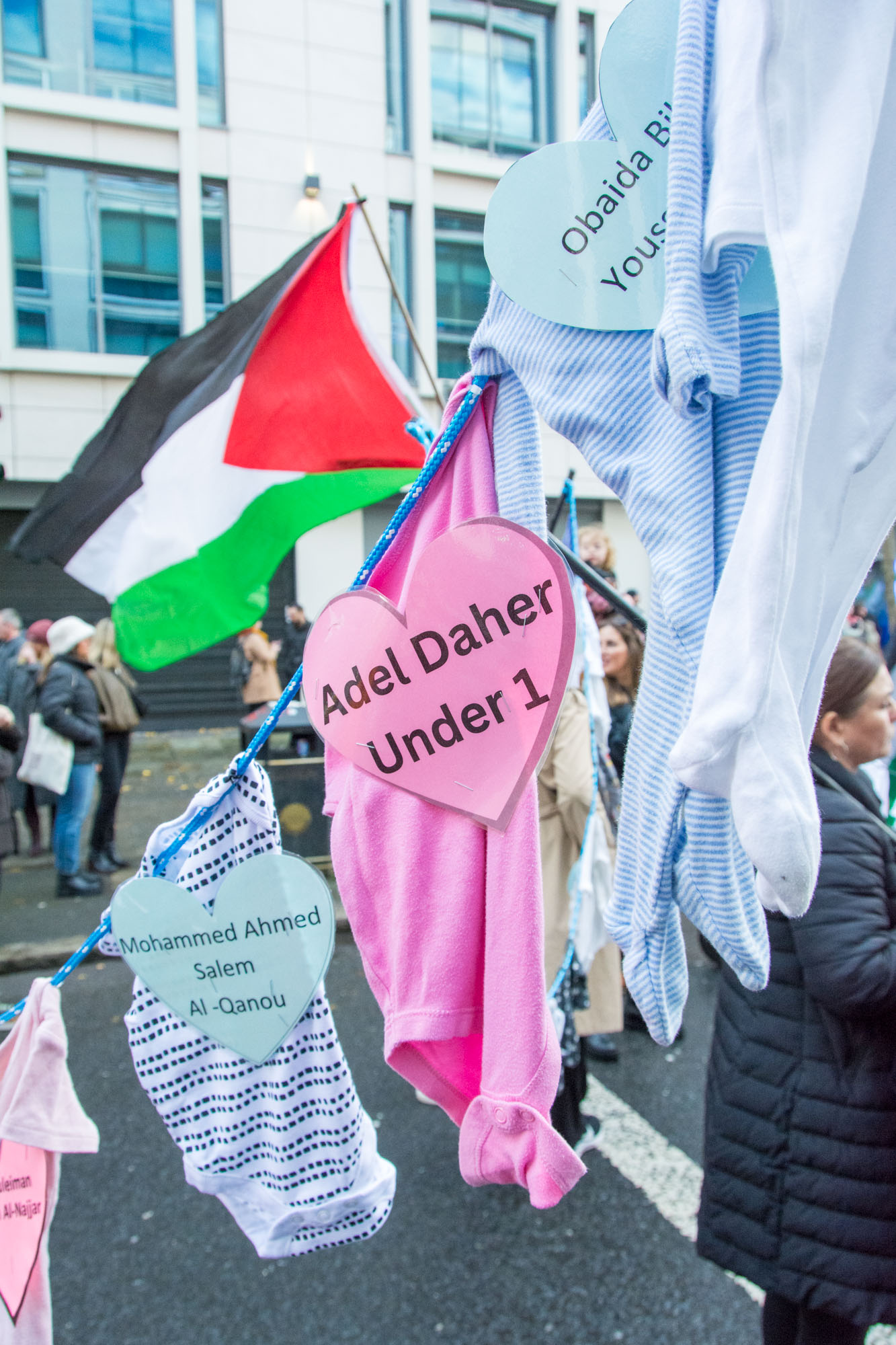 Hearts on baby clothes containing the names of children killed during the ongoing war in Palestine hung as if on washing lines at the Palestine march in Belfast. Photo 7709 by Stephen S T Bradley
