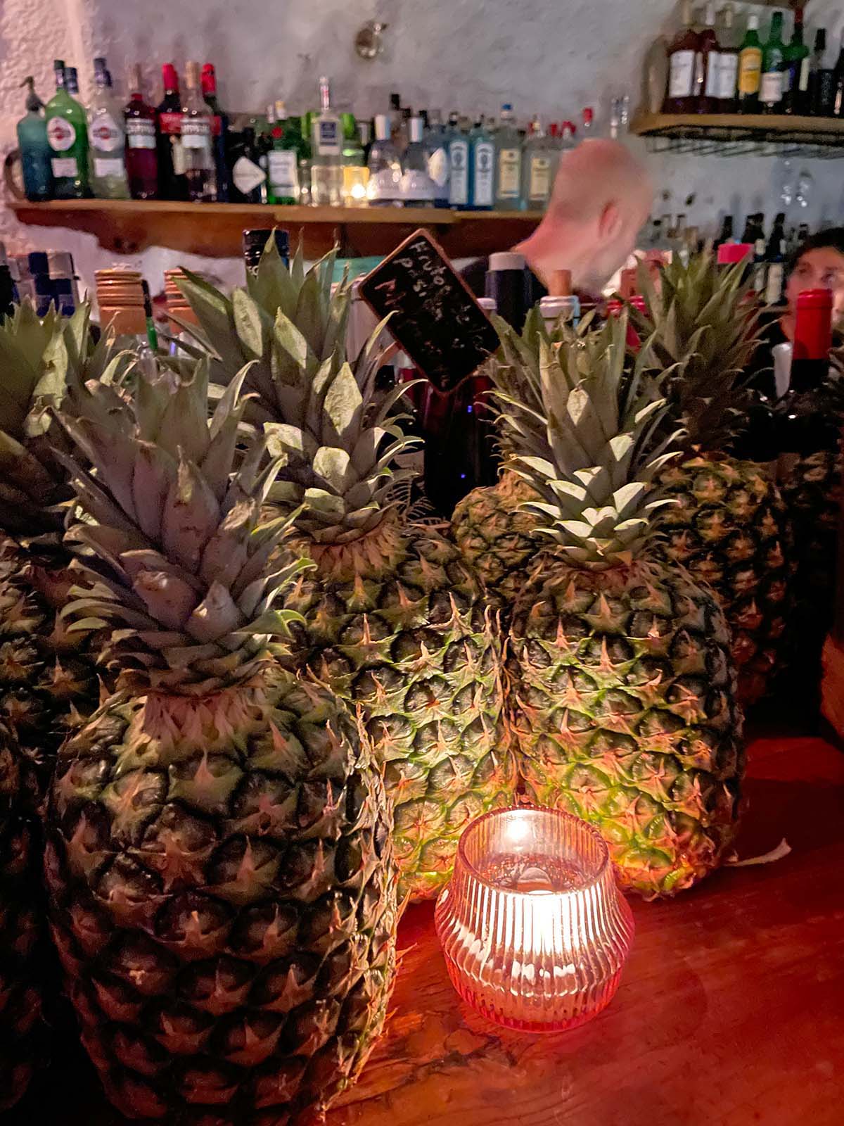 Fresh pineapples  used to make fruit smoothies, pictured beside a lit teatree candle at the Brown Sugar Bar in Cadaques, Spain - photo 3501